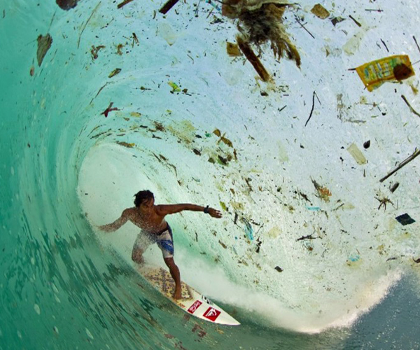 the problem: surfer riding a wave full of trash